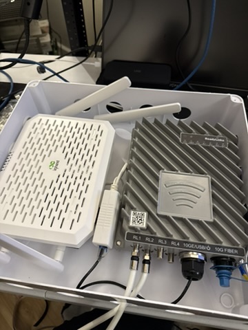 InHand FWA02 installed alongside a Ubiquiti Dream Machine in an outdoor enclosure